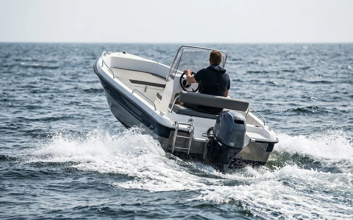 Small outboard boat bouncing bow-up over its wake at speed